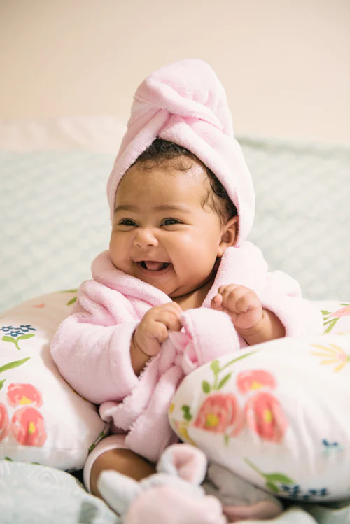 Happy baby in a towel