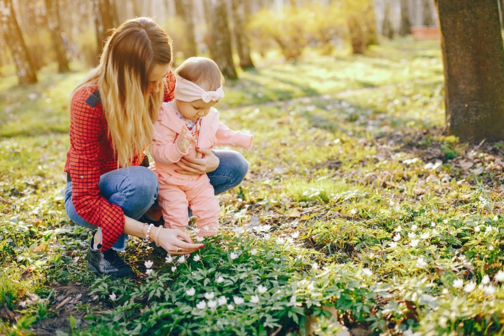 Spring baby names 2023 - mother and baby in spring field