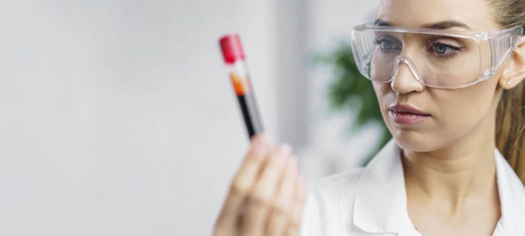 Lady holding blood sample - NIPT testing