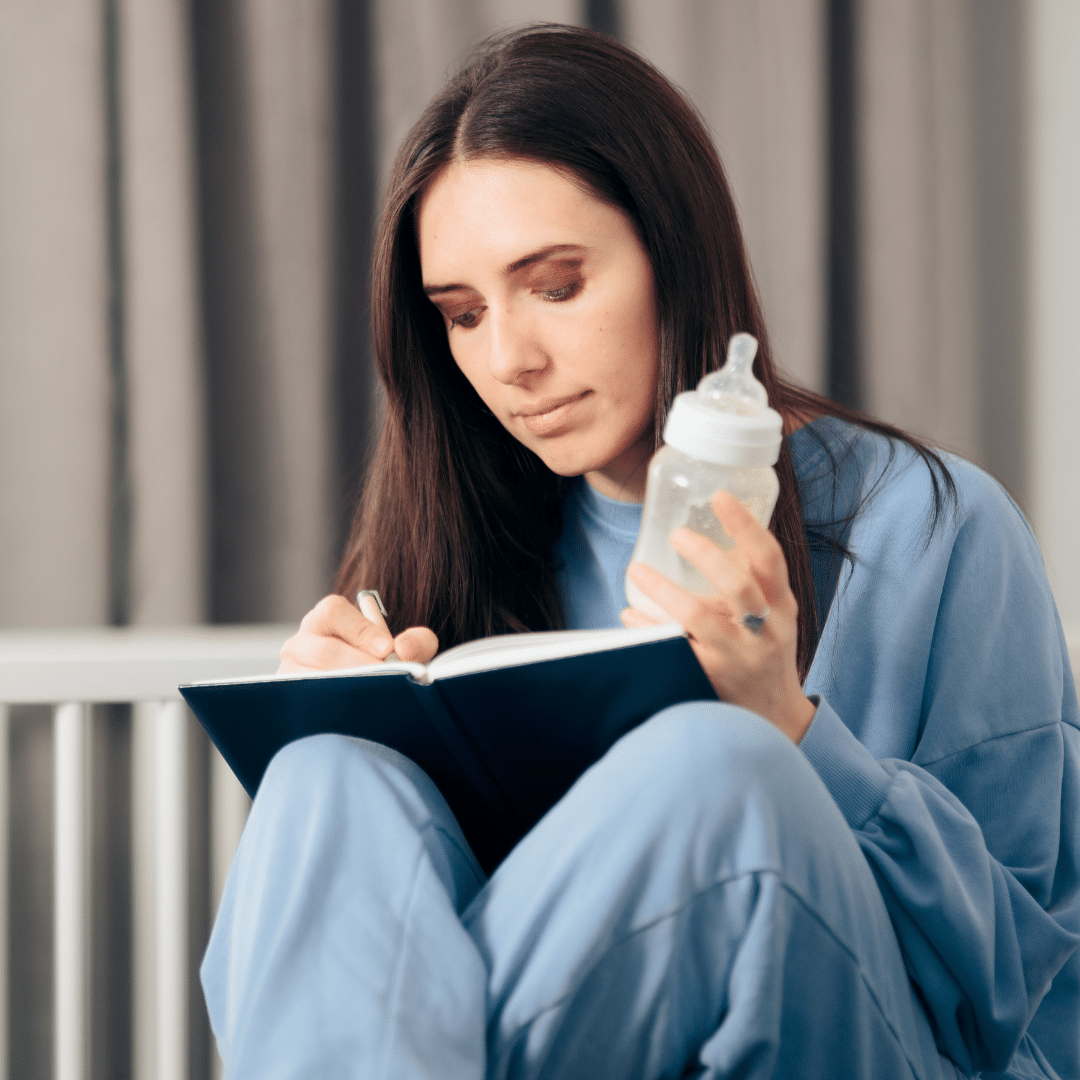 Lady in blue with baby bottle and journal